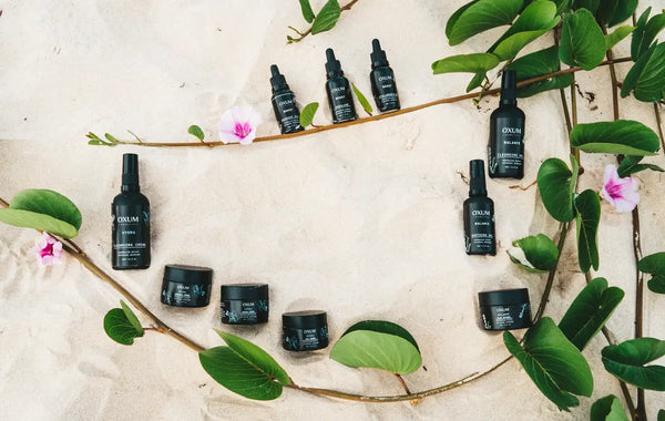 All the oxum skincare products placed in the sand