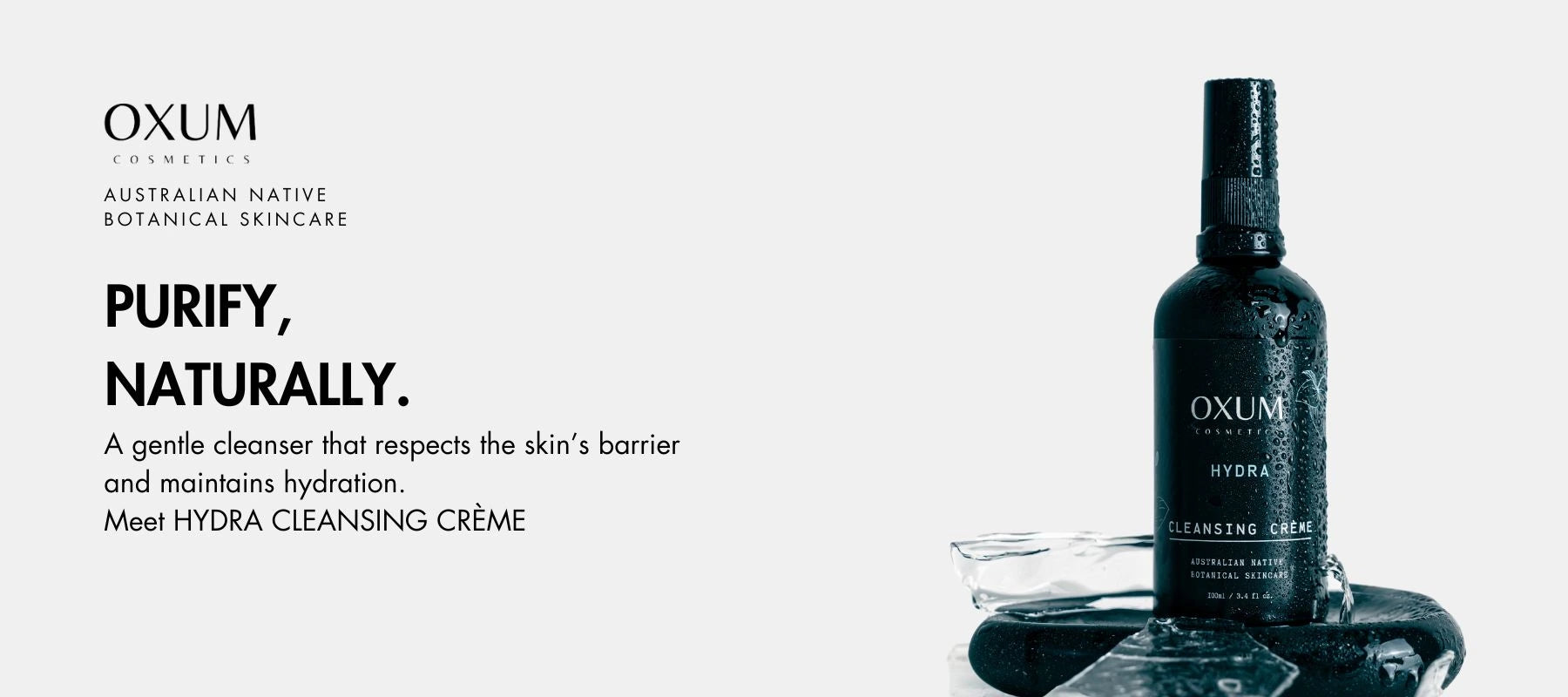 bottle of HYDRA Cleanser standing on a black stone