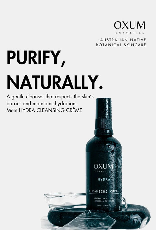 bottle of HYDRA Cleanser standing on a black stone